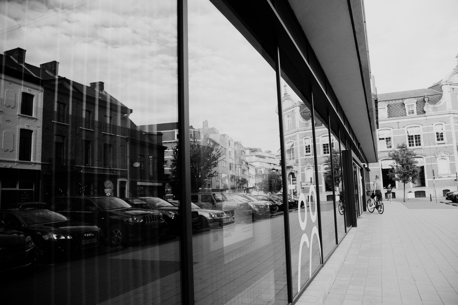 Monochrome stadsbeeld met glasreflecties en straatzicht.