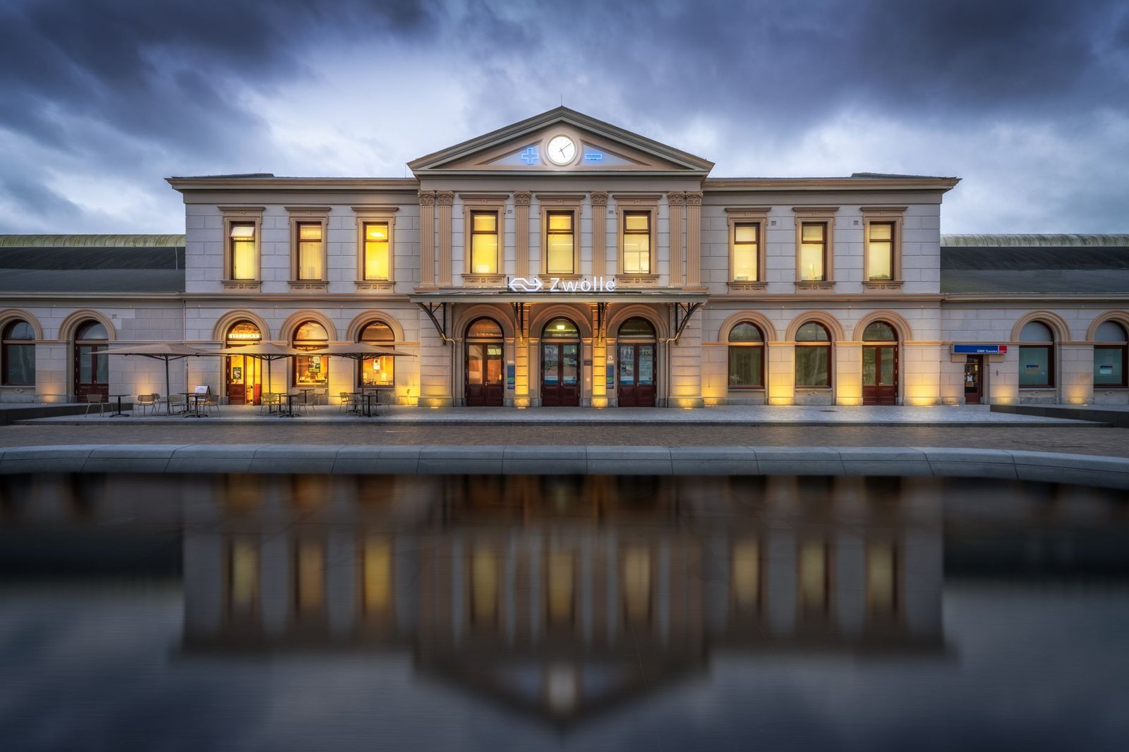 Scenic view of Zwolle railway station with lights and reflection at twilight, Overijssel, Netherlands.