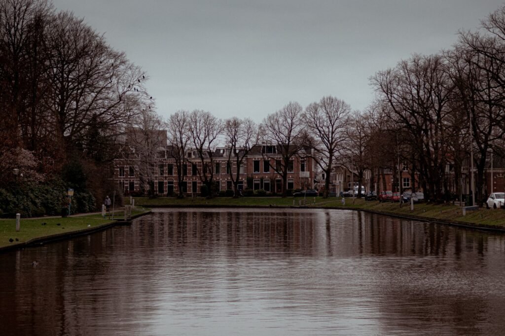 Discover the tranquil beauty of a canal lined with historic architecture in Leeuwarden, Netherlands.
